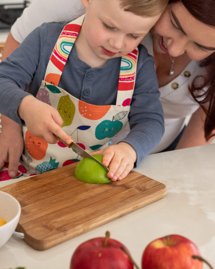 adult and child cutting apple with kiddikutter knife