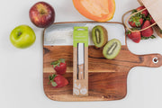 picture of packaged kiddikutter knife with fruits around it